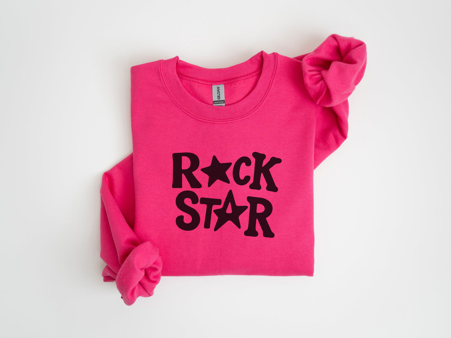 A pink sweatshirt with the text "ROCK STAR" printed on it.